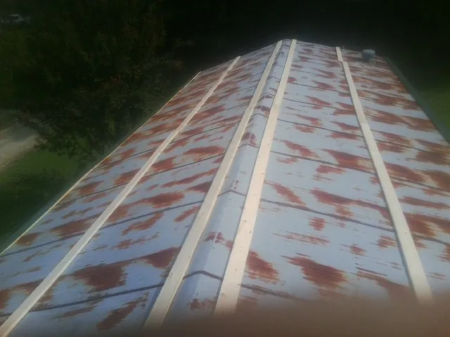 Rusted metal roof panels with new wood purlins before replacement — Storm Damage Roof Repair in Catlett by Roofing Brothers