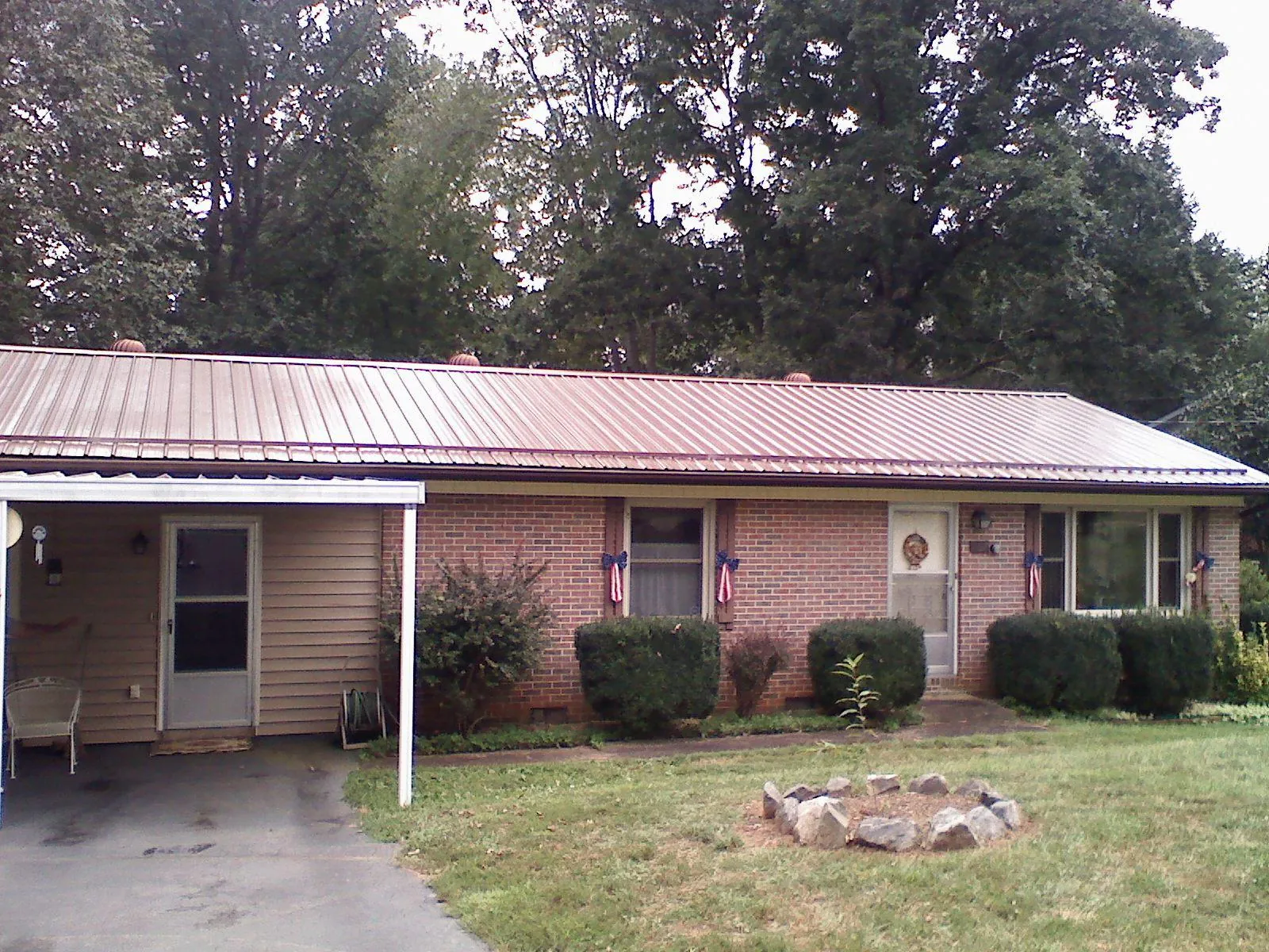 Bronze metal roof and carport on a brick ranch home — Roof Repair work by our crew in Catlett